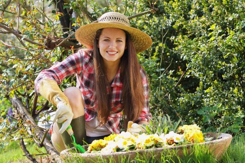 Worker using protective equipment during garden maintenance